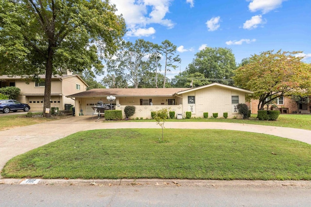 view of front of property with a garage and a front lawn