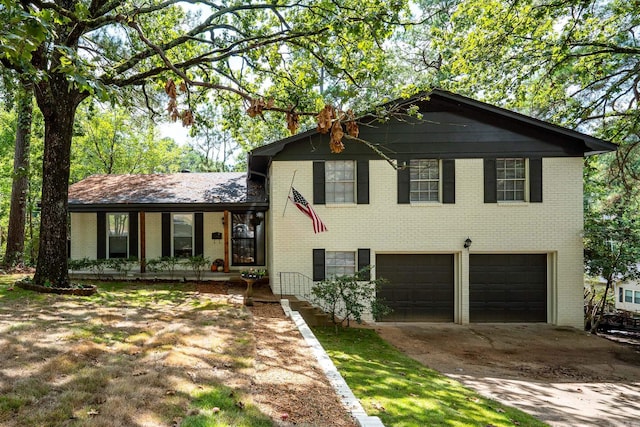 split level home featuring a garage and covered porch