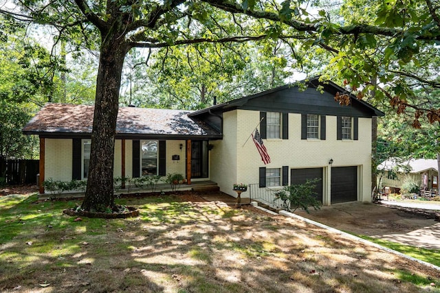 split level home with covered porch and a garage