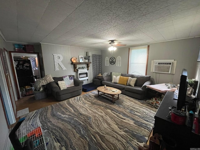 living room featuring a wall unit AC, ceiling fan, and hardwood / wood-style flooring