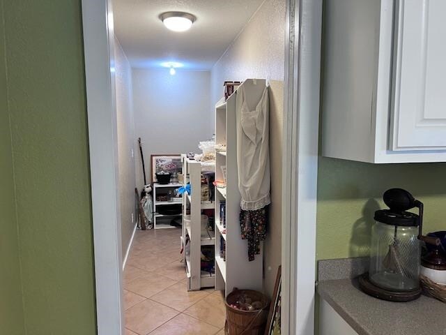 hallway with light tile patterned floors