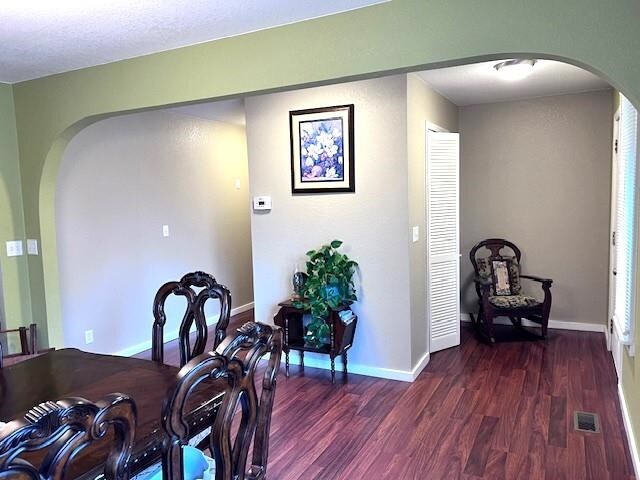 dining area with dark hardwood / wood-style floors