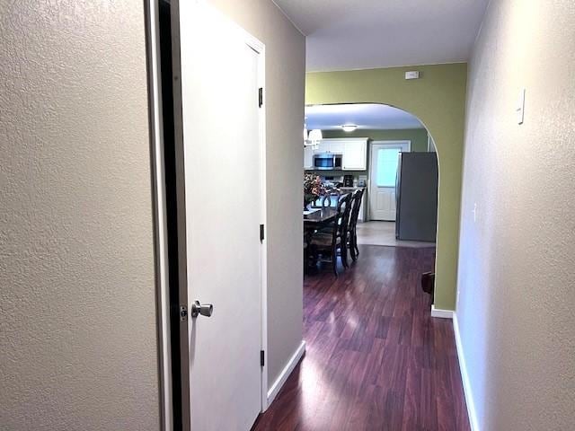 corridor with dark hardwood / wood-style floors