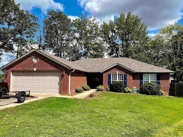 ranch-style home with a garage and a front lawn