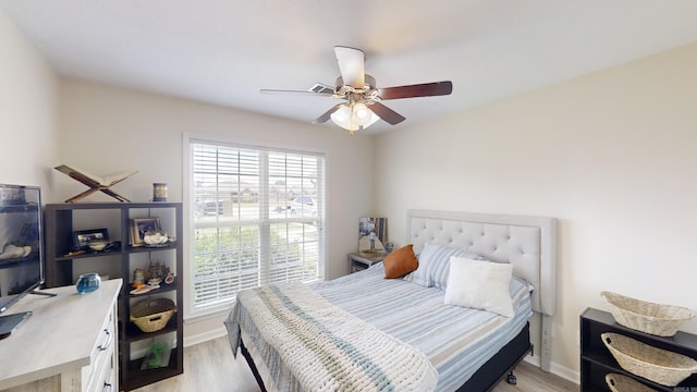 bedroom featuring light hardwood / wood-style floors and ceiling fan