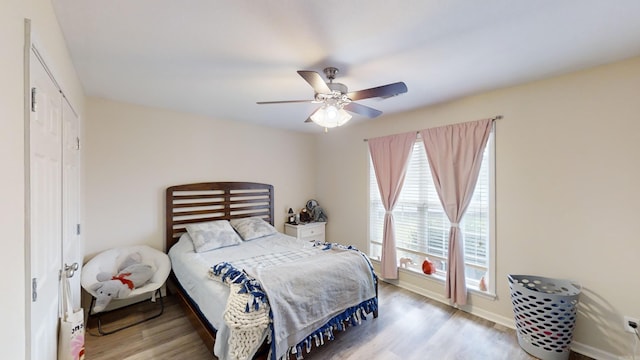 bedroom featuring light wood-type flooring and ceiling fan