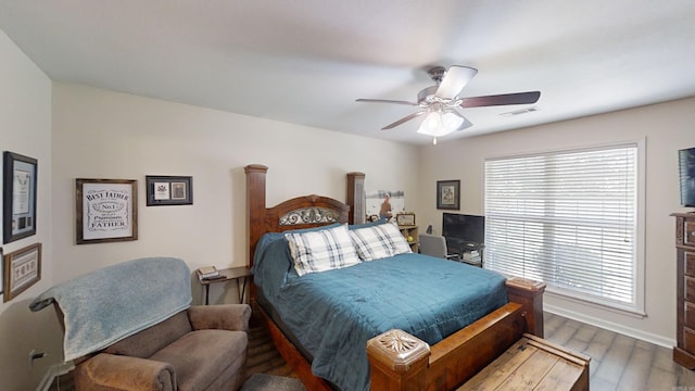 bedroom with wood-type flooring and ceiling fan