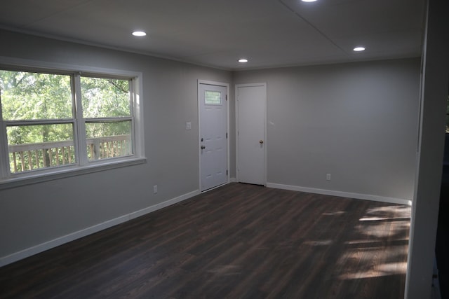 unfurnished room with dark hardwood / wood-style flooring