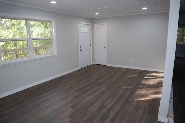 unfurnished room with dark wood-type flooring and crown molding