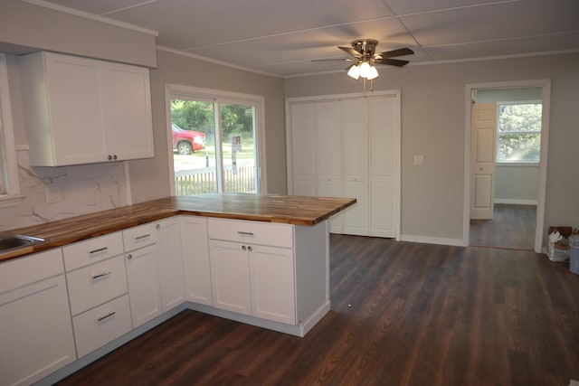 kitchen with white cabinets, butcher block counters, and ceiling fan