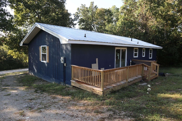 rear view of property featuring a deck