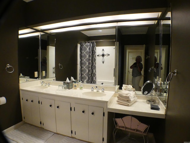 bathroom featuring vanity and curtained shower