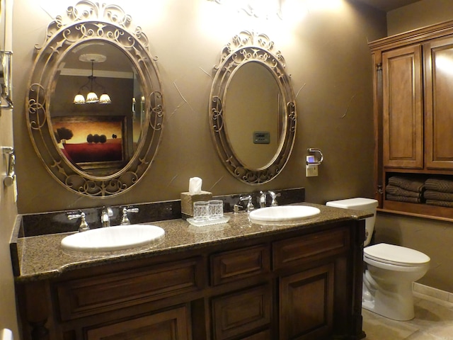 bathroom featuring crown molding, vanity, and toilet