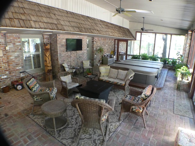 sunroom / solarium with lofted ceiling, ceiling fan, and plenty of natural light