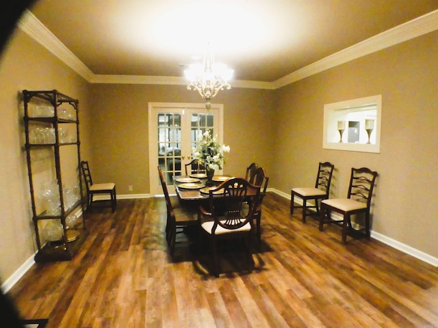 dining room featuring an inviting chandelier, crown molding, french doors, and dark hardwood / wood-style flooring