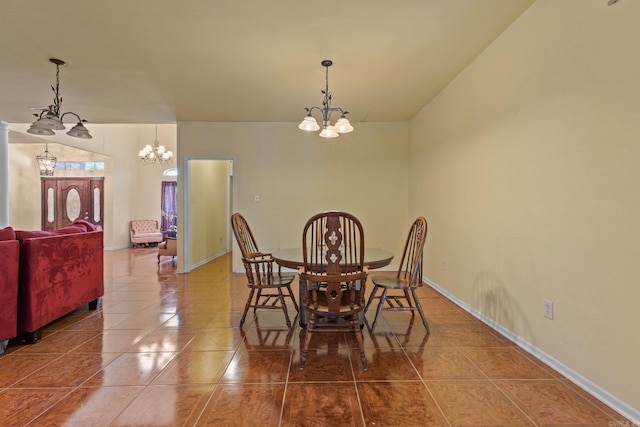 tiled dining space with a chandelier