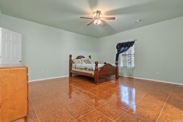 tiled bedroom featuring ceiling fan