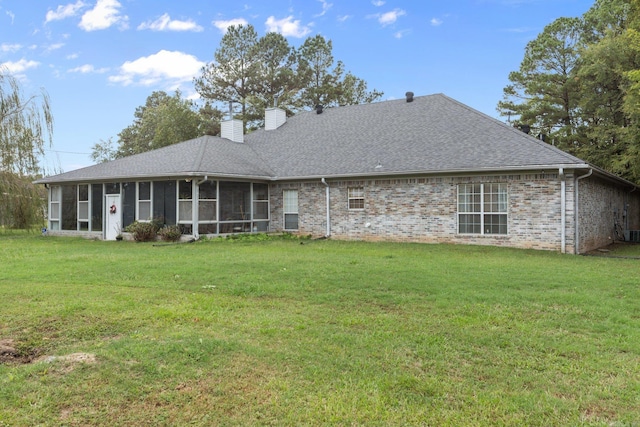 back of house with a sunroom and a lawn