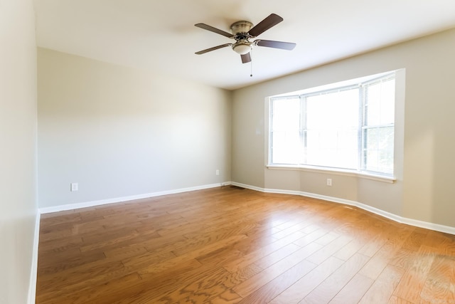 unfurnished room featuring light hardwood / wood-style floors and ceiling fan