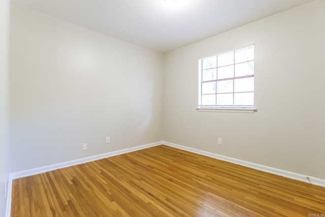 empty room with wood-type flooring