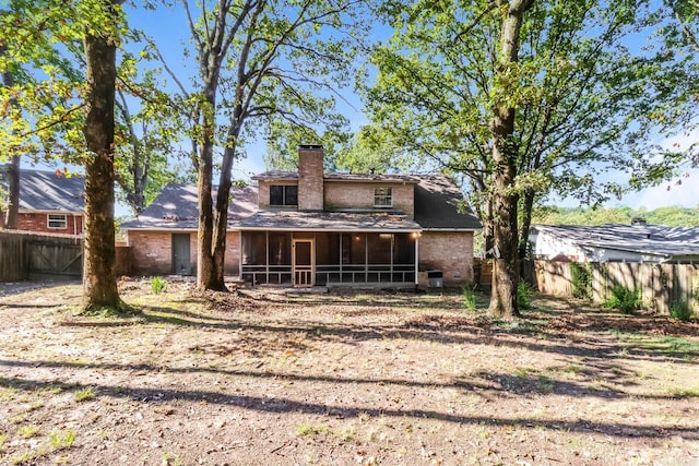 back of property with a sunroom