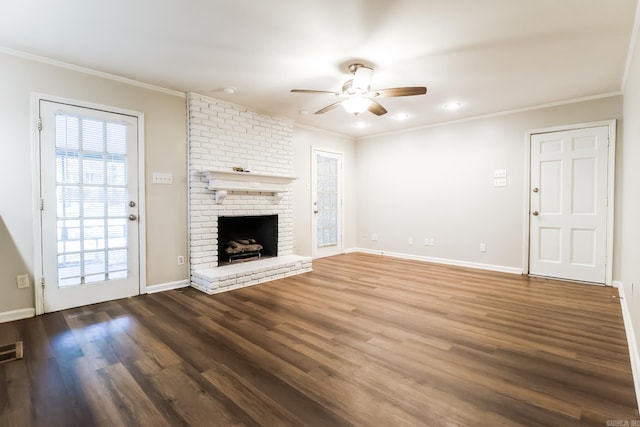 unfurnished living room featuring a brick fireplace, ceiling fan, hardwood / wood-style floors, and crown molding