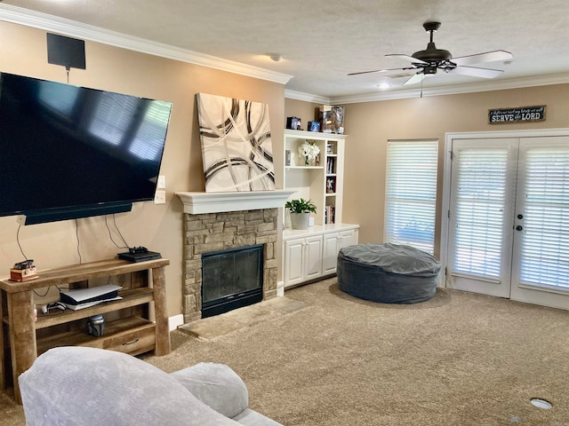 living room with carpet floors, crown molding, a stone fireplace, and ceiling fan