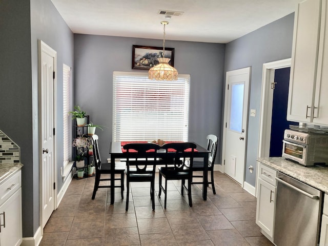 dining area with dark tile patterned flooring