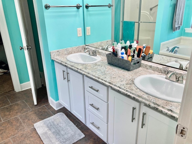 bathroom with tile patterned floors, vanity, and a bathtub