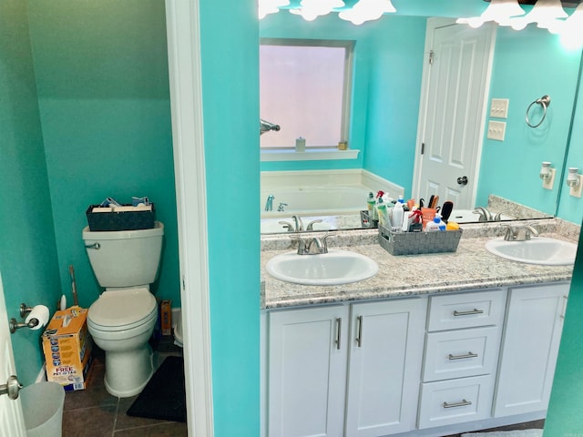 bathroom with a bathing tub, tile patterned floors, vanity, and toilet