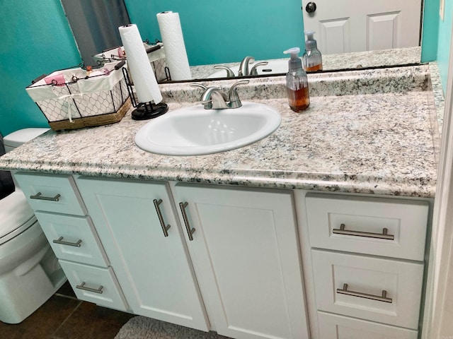 bathroom featuring tile patterned floors, vanity, and toilet