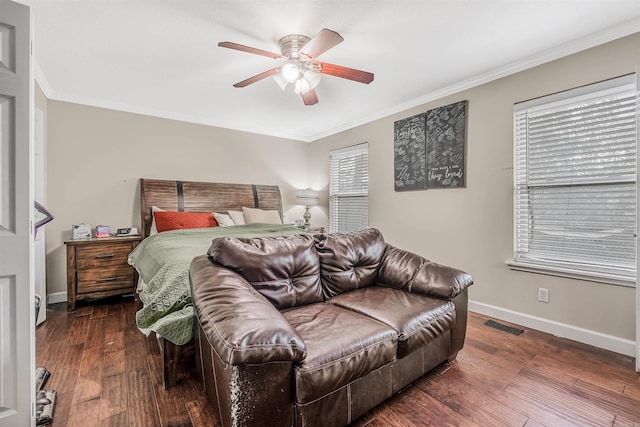 bedroom with ceiling fan, crown molding, and dark hardwood / wood-style flooring