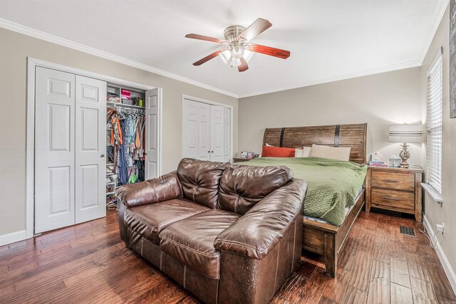 bedroom with ornamental molding, dark hardwood / wood-style floors, and ceiling fan