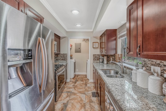 kitchen featuring decorative backsplash, light stone counters, electric panel, stainless steel appliances, and sink