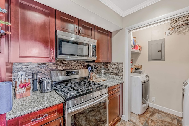 kitchen featuring appliances with stainless steel finishes, decorative backsplash, light stone counters, washer / dryer, and electric panel