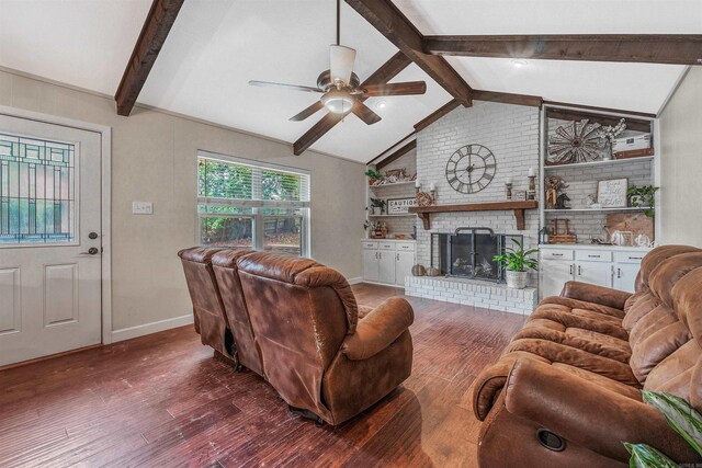 living room featuring ceiling fan, a fireplace, dark hardwood / wood-style floors, and lofted ceiling with beams