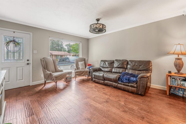 living room with wood-type flooring and ornamental molding