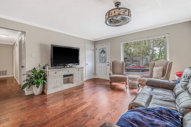 living room featuring dark hardwood / wood-style floors and crown molding