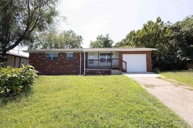 single story home featuring a garage, a front lawn, and covered porch