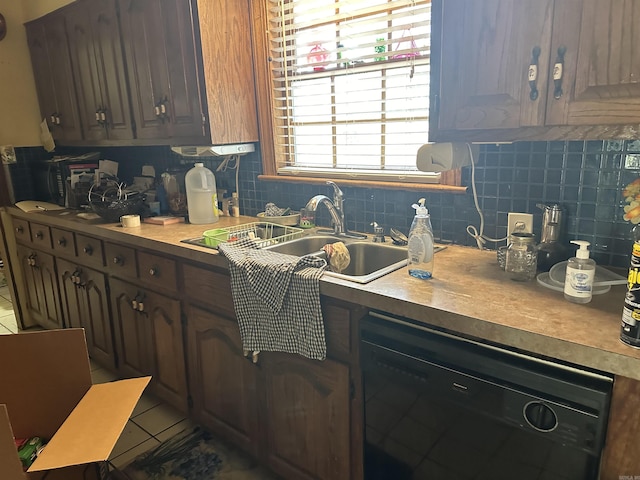 kitchen featuring black dishwasher, tasteful backsplash, sink, dark brown cabinets, and tile patterned floors