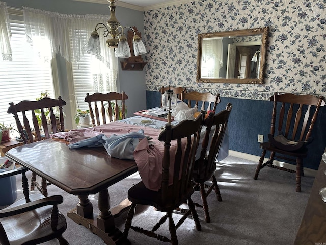 carpeted dining room featuring ornamental molding