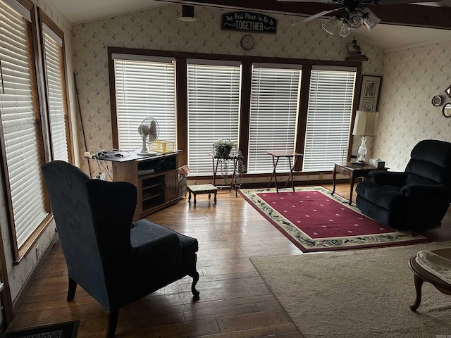 living room with hardwood / wood-style floors, vaulted ceiling, and ceiling fan