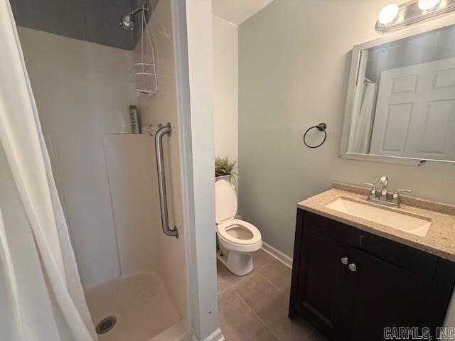 bathroom featuring toilet, curtained shower, vanity, and tile patterned flooring