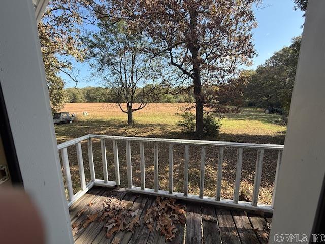 wooden terrace featuring a rural view