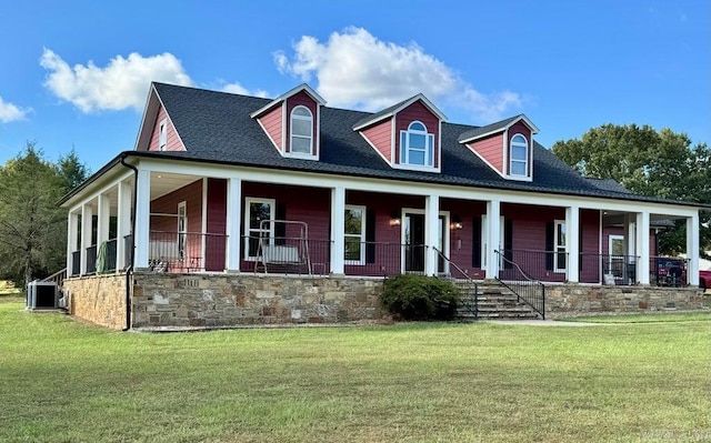 cape cod house with central AC unit, a front yard, and a porch