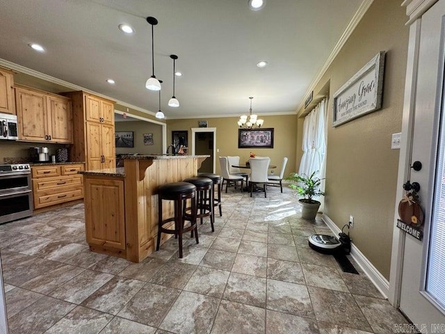 kitchen featuring hanging light fixtures, a breakfast bar, stainless steel appliances, ornamental molding, and a notable chandelier