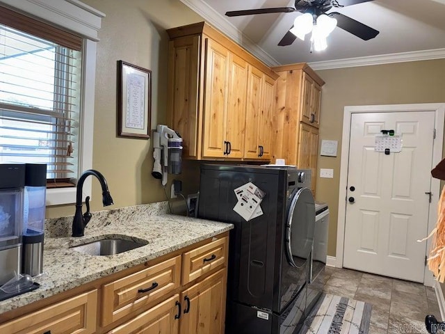 laundry area with ornamental molding, cabinets, plenty of natural light, and sink