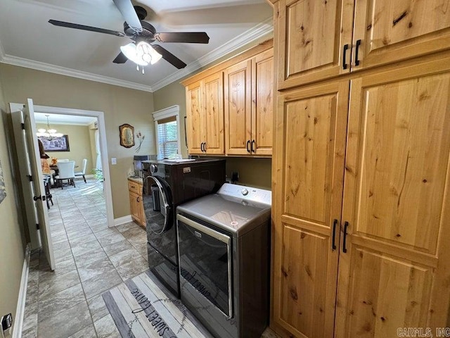 laundry room with cabinets, ceiling fan with notable chandelier, ornamental molding, and washing machine and dryer