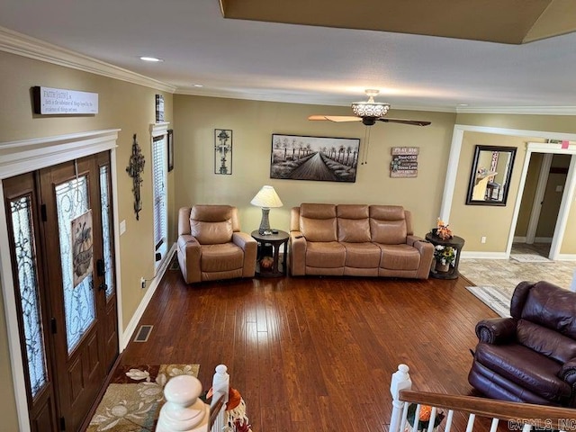 living room featuring ceiling fan, ornamental molding, and dark hardwood / wood-style flooring