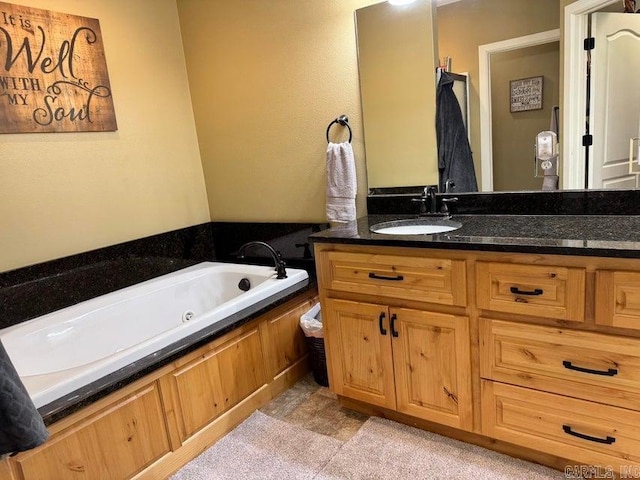 bathroom featuring a washtub and vanity